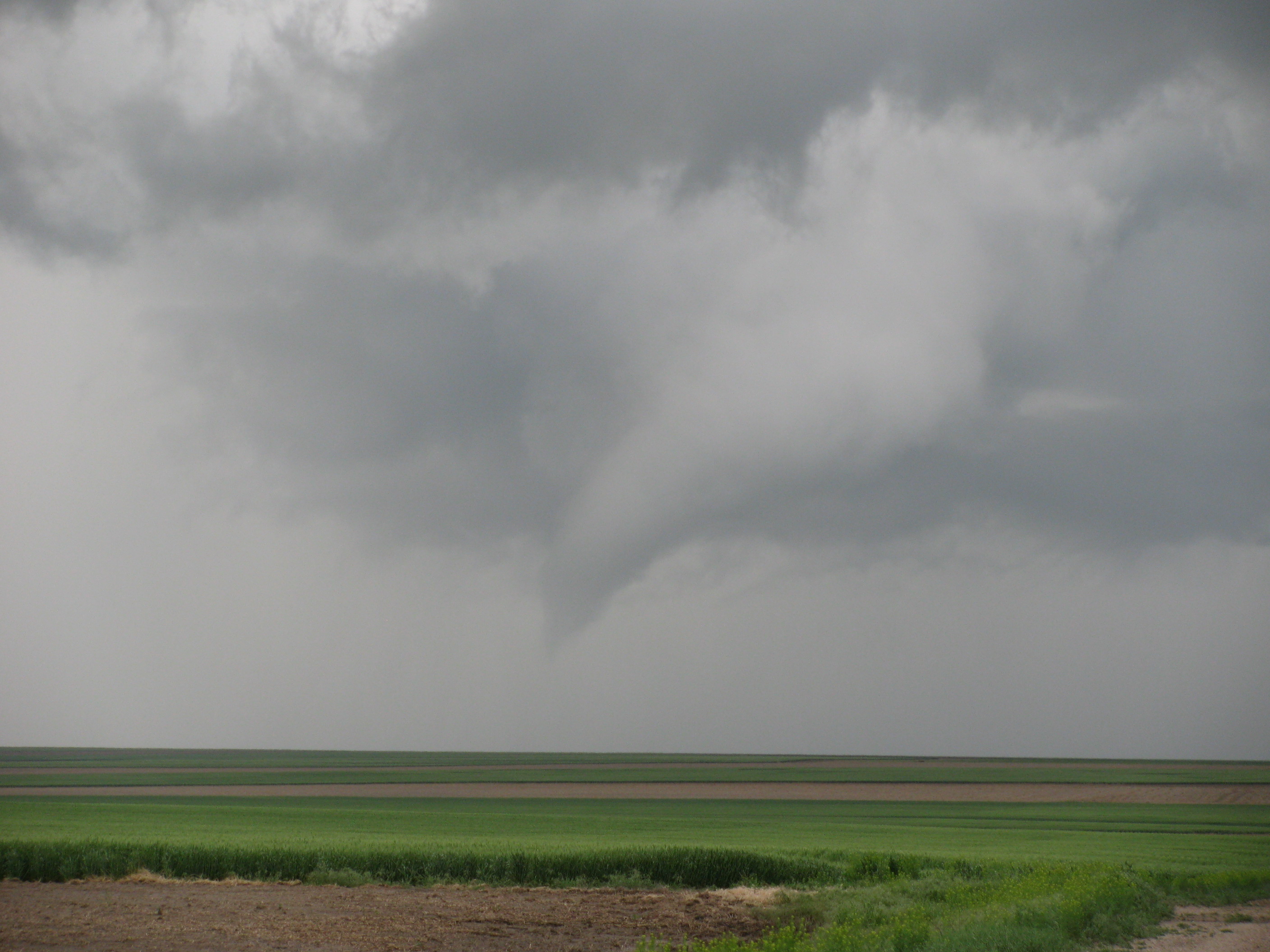 a funnel cloud forming beneath a severe thunderstorm